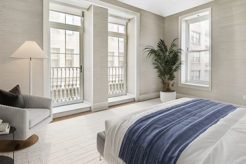 Bedroom with grasscloth walls at 1 Central Park South 701, Central Park South — photo 5 of 7