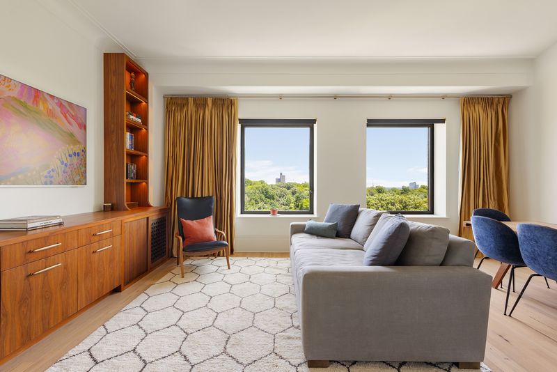 Living room with Prospect Park treetop views at One Prospect Park West, PHC, Park Slope