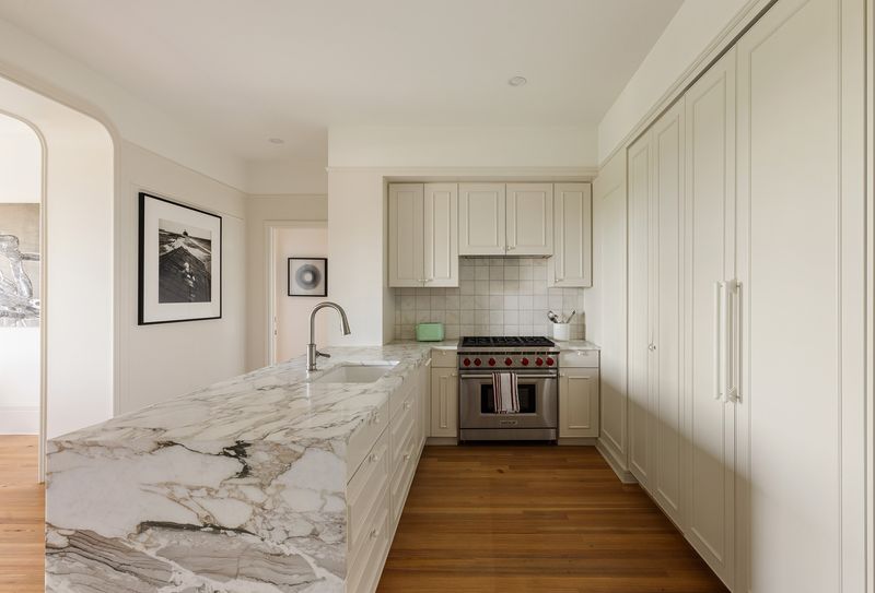 Kitchen with Estremoz marble and Wolf range at One Prospect Park West, PHC, Park Slope — photo 3 of 9