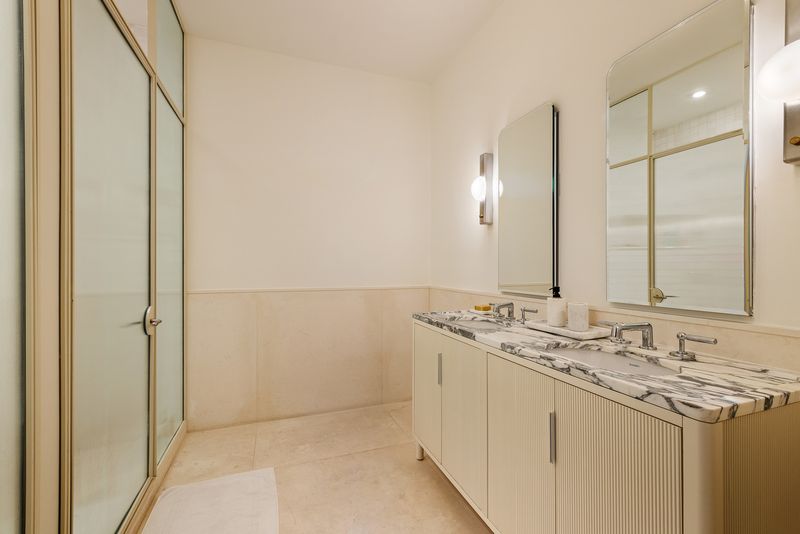 Primary bath with marble double vanity at One Prospect Park West, PHC, Park Slope — photo 7 of 9