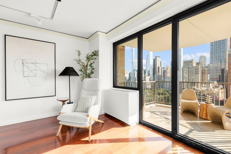Living room opening to the balcony at 10 West 66th Street 29E, Lincoln Square — photo 3 of 9