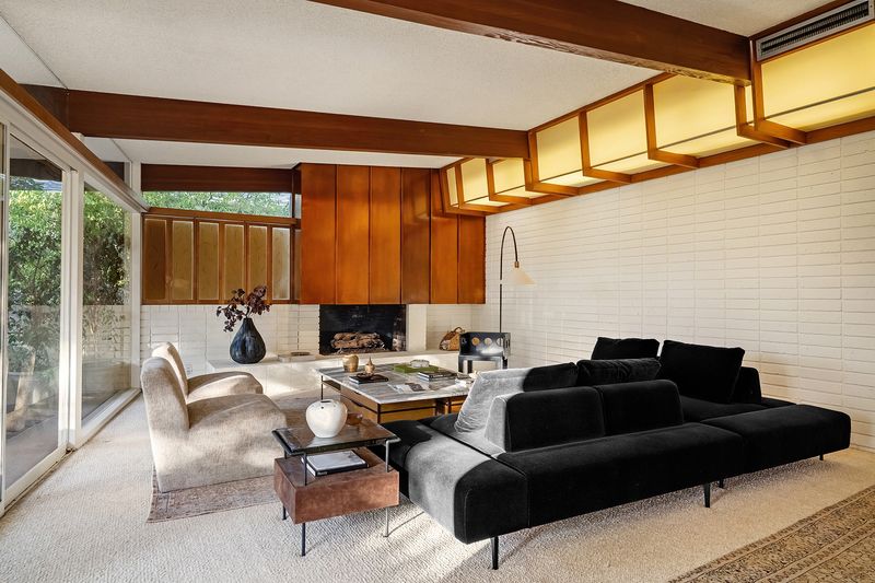 Upstairs living room with walnut paneling and fireplace at 1024 Armada Drive, Pasadena — photo 3 of 9