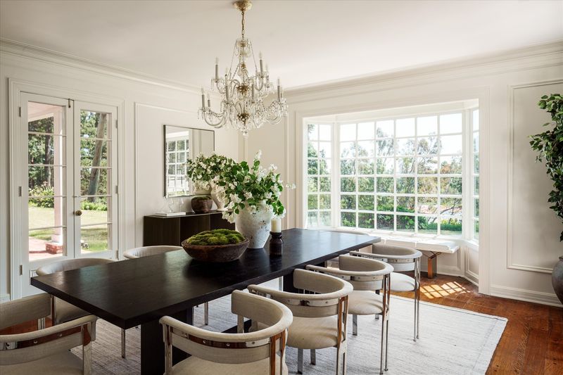 Dining room under a crystal chandelier at 10810 Ambazac Way, Bel Air — photo 6 of 12