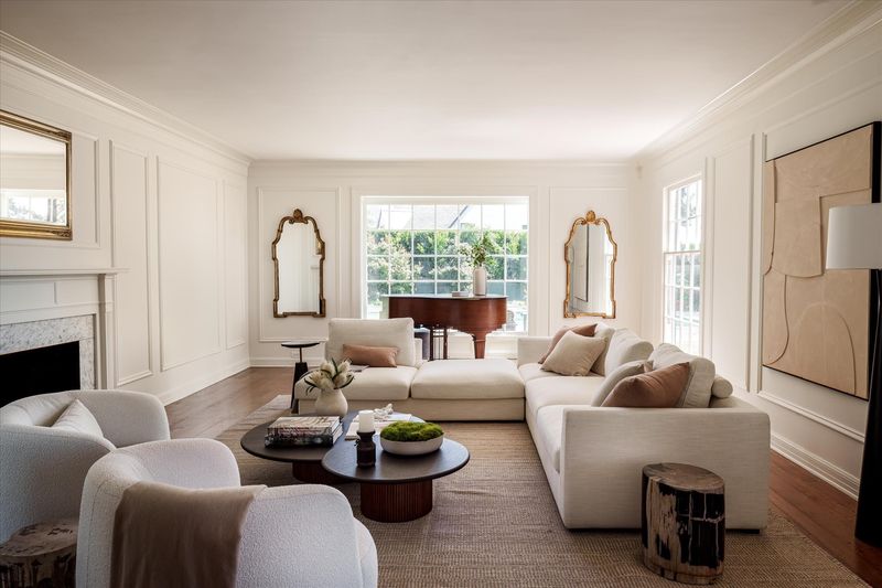 Living room with fireplace and grand piano at 10810 Ambazac Way, Bel Air — photo 10 of 12