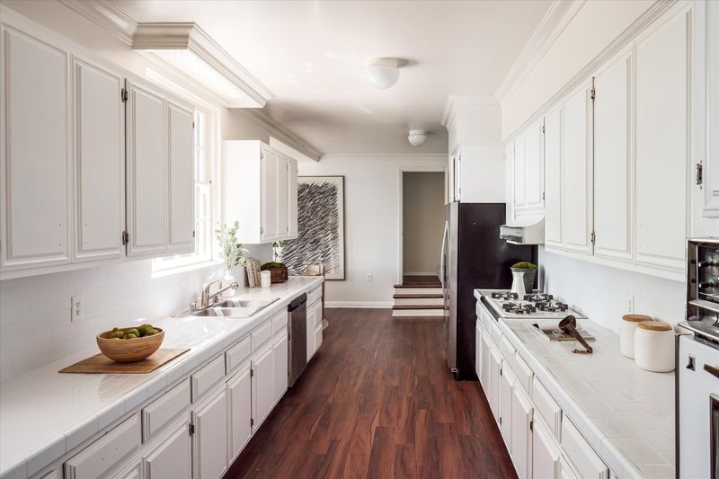 Kitchen with white cabinetry at 10810 Ambazac Way, Bel Air — photo 11 of 12