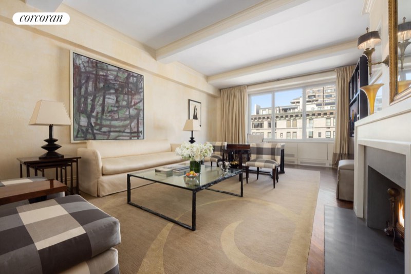Living room toward Park Avenue with the fireplace lit at 1095 Park Avenue 15D, Carnegie Hill
