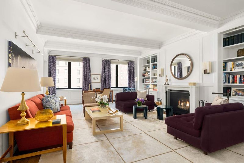 Living room with fireplace and built-ins at 1100 Park Avenue 6B, Carnegie Hill