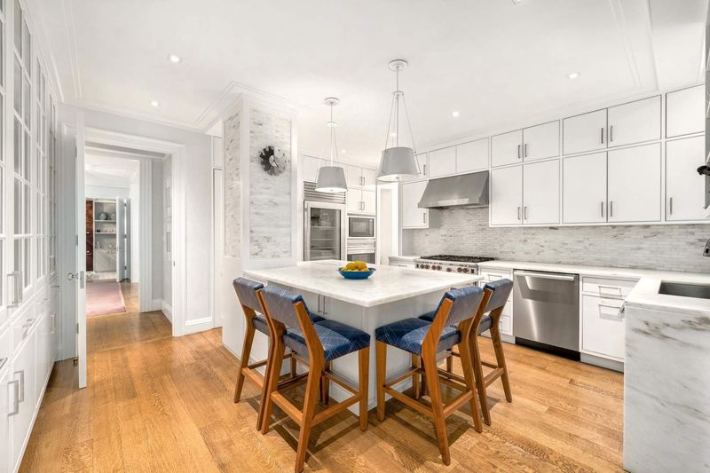 Kitchen with island at 1100 Park Avenue 6B, Carnegie Hill — photo 4 of 10