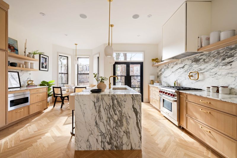 Kitchen with a marble island and Wolf range at 1102 Prospect Place, Crown Heights — photo 3 of 9