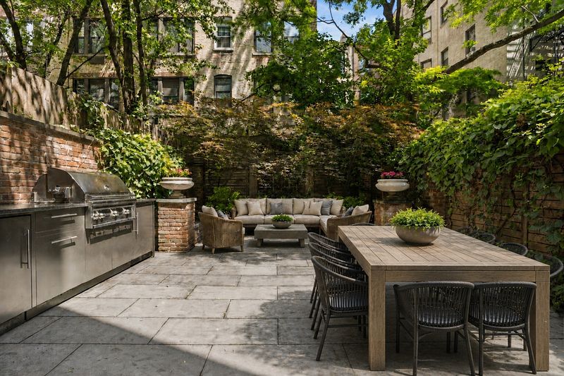 Landscaped rear garden with outdoor kitchen and dining at 111 East 81st Street, Upper East Side — photo 5 of 8