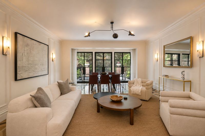 Living room with garden-facing windows at 111 East 81st Street, Upper East Side — photo 8 of 8