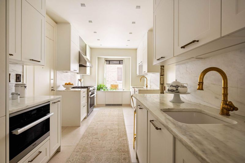 Windowed kitchen at 1130 Park Avenue 91, Carnegie Hill — photo 4 of 11