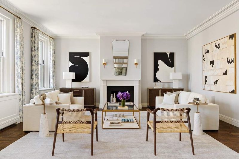 Living room with a fireplace and tall windows over Park Avenue at 1155 Park Avenue 10SW, Carnegie Hill