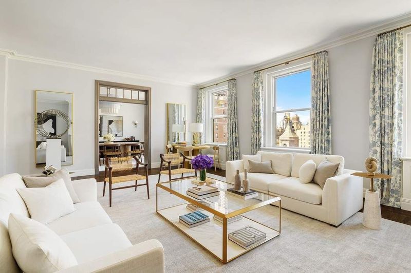 Living room seating area looking toward the corner windows at 1155 Park Avenue 10SW, Carnegie Hill — photo 2 of 12