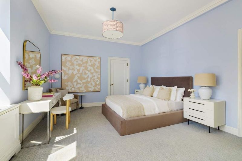 Bedroom with soft blue walls and a writing desk at 1155 Park Avenue 10SW, Carnegie Hill — photo 9 of 12