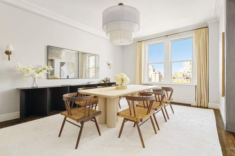 Formal dining room with a round table and tall windows at 1155 Park Avenue 10SW, Carnegie Hill — photo 11 of 12