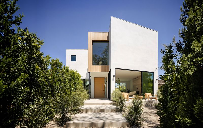 White facade with cedar accents at 116 S Gretna Green Way, Brentwood — photo 2 of 10