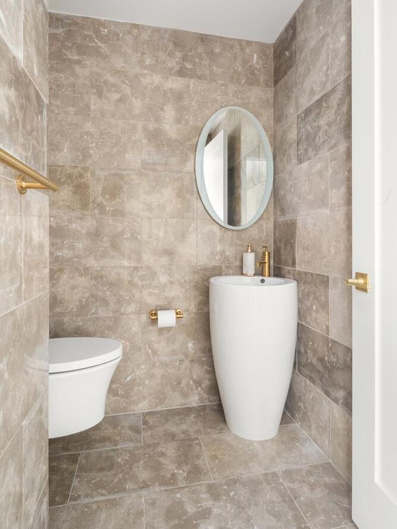 Powder room with pedestal sink at 1200 Fifth Avenue 15A, Carnegie Hill — photo 9 of 13