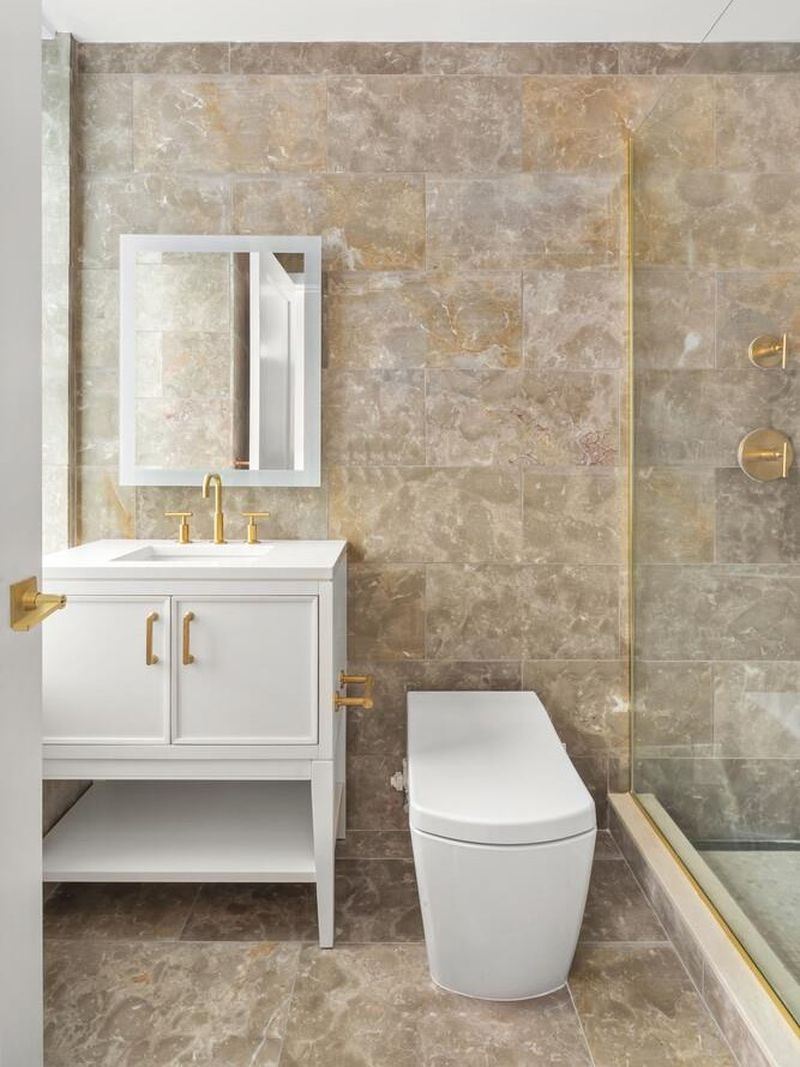 Guest bath with vanity in stone tile at 1200 Fifth Avenue 15A, Carnegie Hill — photo 10 of 13