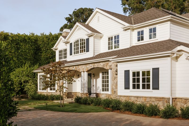 Front facade with a stone-trimmed entry at 1228 Amalfi Drive, Pacific Palisades — photo 2 of 12