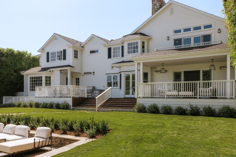 Rear facade over the lawn and covered deck at 1228 Amalfi Drive, Pacific Palisades — photo 3 of 12