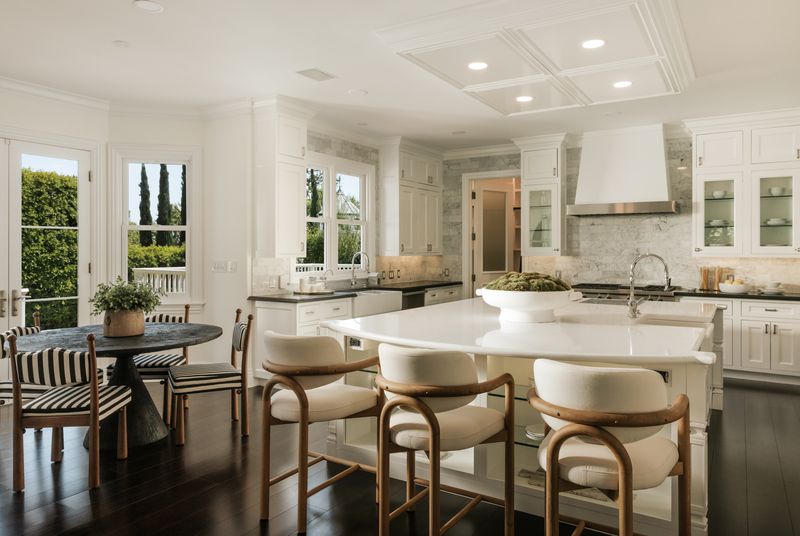 Kitchen with stone-topped island and breakfast area at 1228 Amalfi Drive, Pacific Palisades — photo 7 of 12