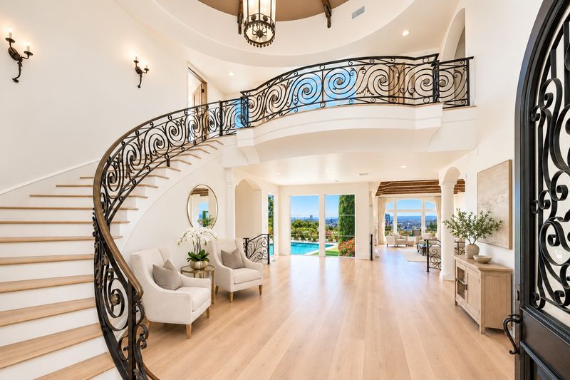 Grand foyer with a sweeping staircase at 1260 St Ives Place, Bird Streets, Hollywood Hills — photo 3 of 6