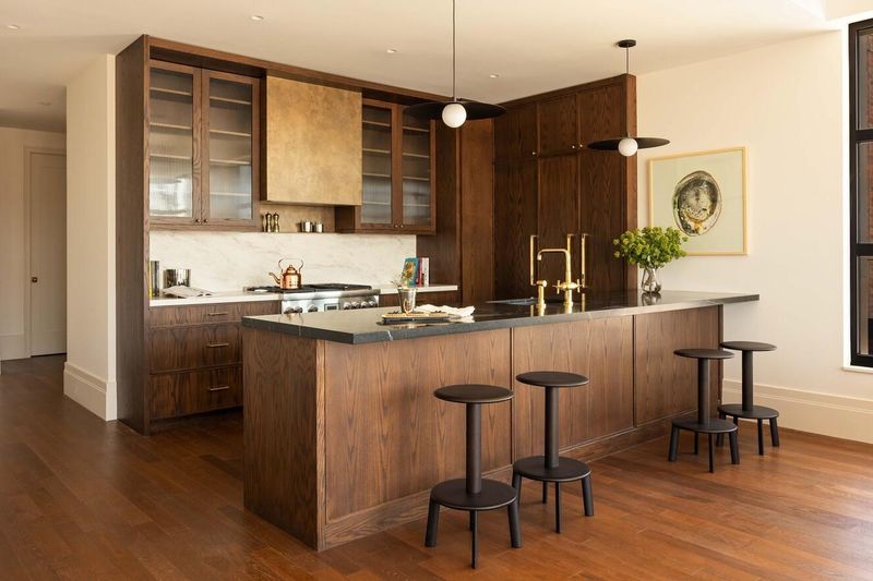 Kitchen island with brass footings at 127 Kent Avenue PH1A, Williamsburg — photo 4 of 8