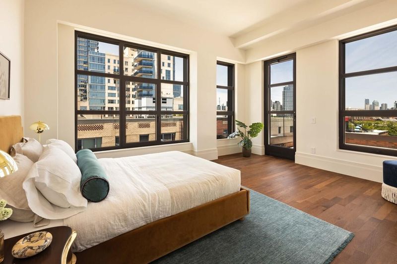 Primary bedroom with skyline views at 127 Kent Avenue PH1A, Williamsburg — photo 5 of 8