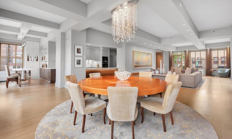 Dining area with crystal chandelier at 130 West 30th Street 18A, Chelsea / NoMad — photo 2 of 8
