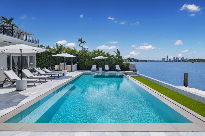 The infinity-edge pool and deck, looking out over Biscayne Bay at 1300 South Venetian Way, San Marco Island