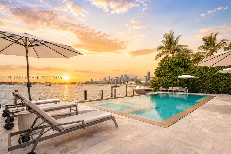 The pool at sunset, with the downtown Miami skyline across the bay at 1300 South Venetian Way, San Marco Island — photo 2 of 10