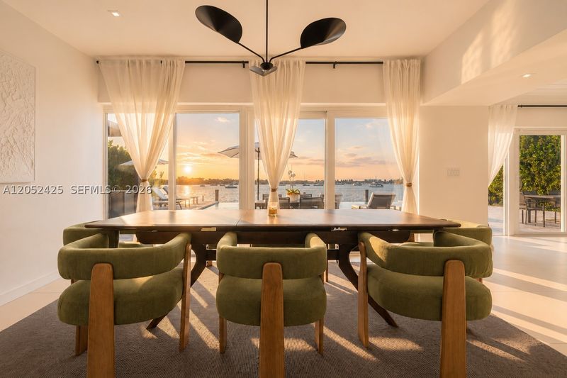 The dining area, set against water views at sunset at 1300 South Venetian Way, San Marco Island — photo 5 of 10