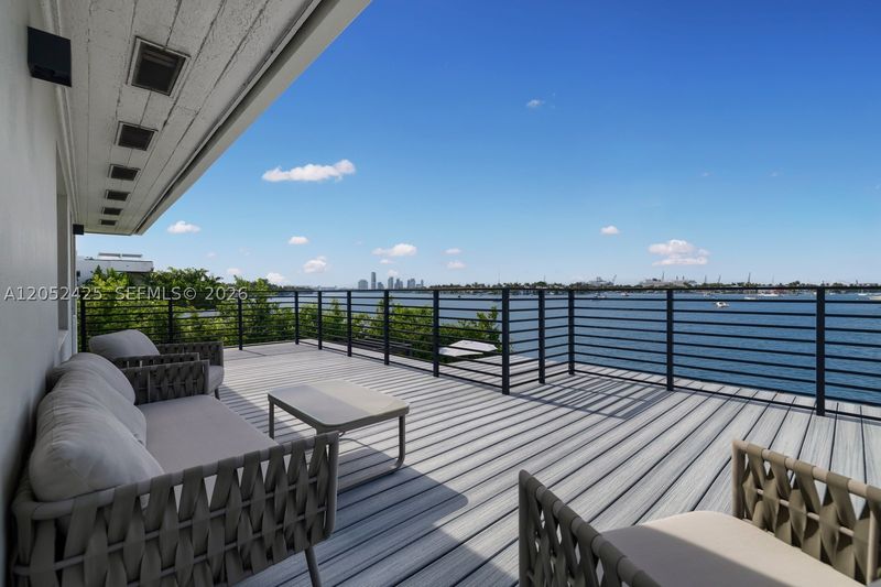 The waterfront balcony, with open bay views at 1300 South Venetian Way, San Marco Island — photo 7 of 10