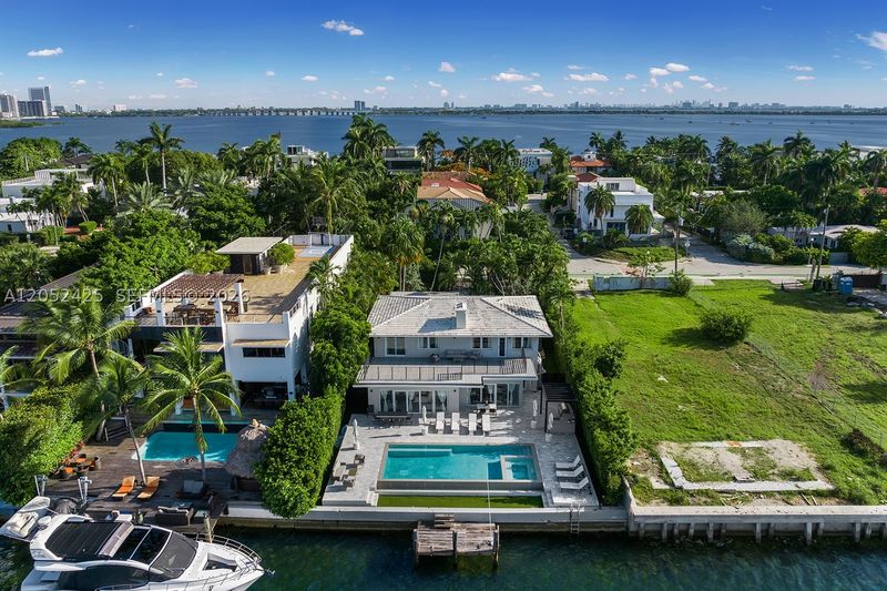 Aerial view of the pool, dock and waterfront at 1300 South Venetian Way, San Marco Island — photo 9 of 10