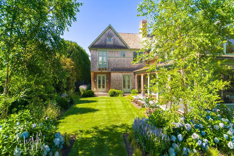 Rear of the shingled house across the lawn and gardens at 134 Herrick Road, Southampton Village — photo 3 of 12