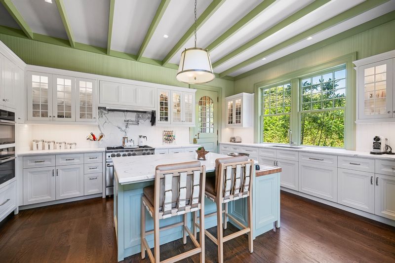Chef's kitchen with custom cabinetry and an island at 134 Herrick Road, Southampton Village — photo 5 of 12