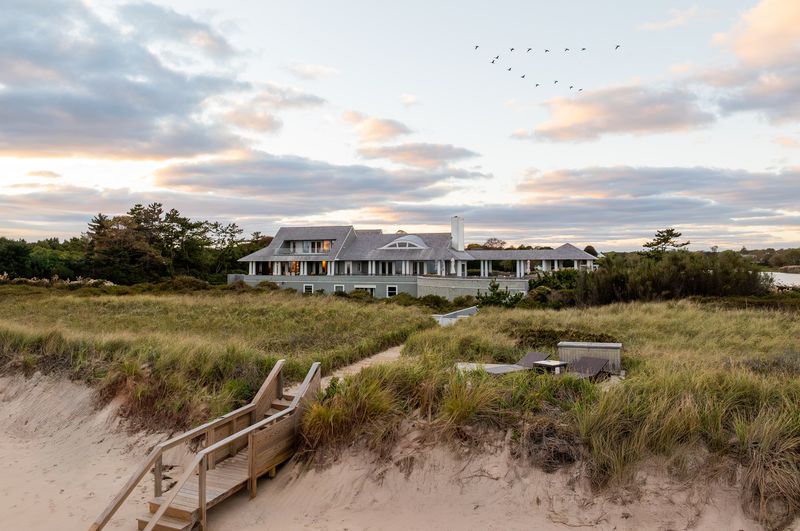 The house from the beach path at dusk at 137 Murray Lane, Southampton Village — photo 10 of 10