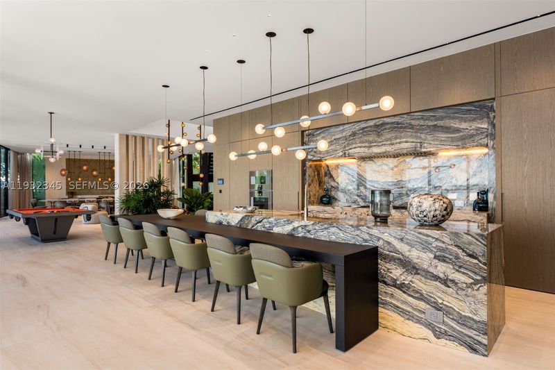 The dining area and display kitchen at 1413 North Venetian Way, San Marco Island — photo 6 of 9