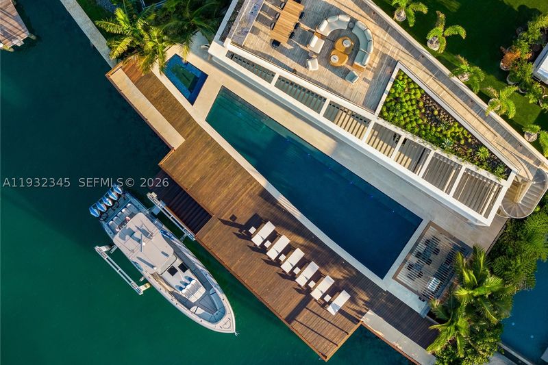 Aerial view of the deep-water dock, pool and rooftop deck at 1413 North Venetian Way, San Marco Island — photo 7 of 9