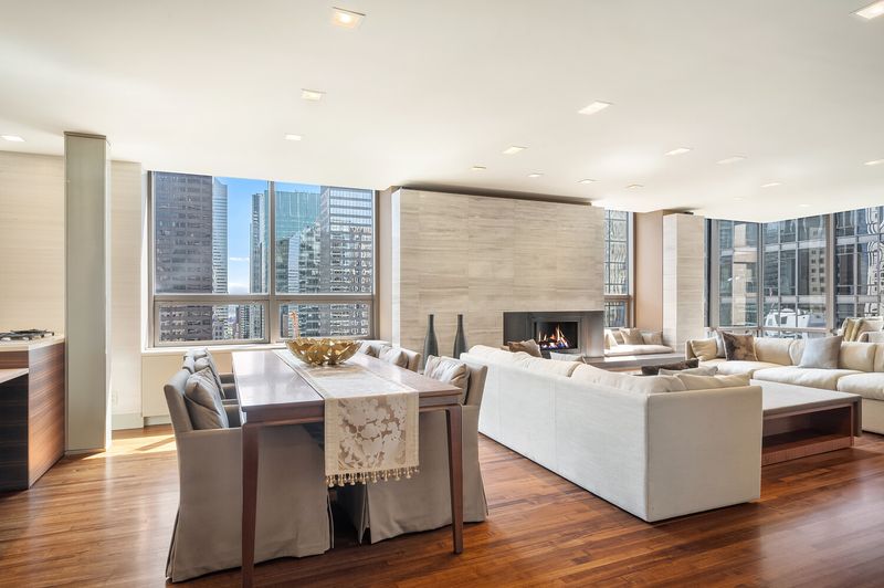 Dining area flowing into the living room at 15 West 53rd Street #29BC, Midtown Manhattan — photo 5 of 12