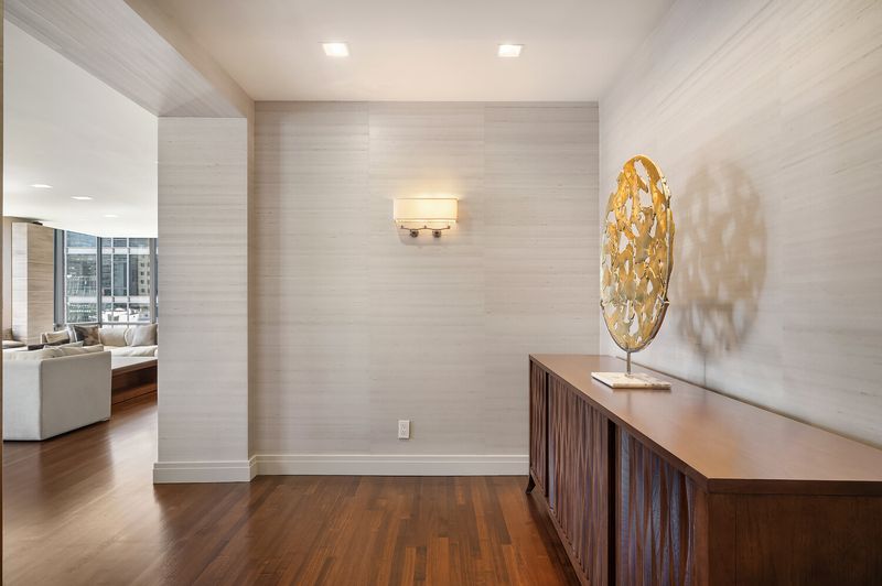 Entry gallery with walnut console at 15 West 53rd Street #29BC, Midtown Manhattan — photo 8 of 12
