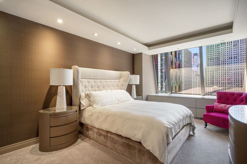 Bedroom (fourth), tufted headboard and city view at 15 West 53rd Street #29BC, Midtown Manhattan — photo 12 of 12