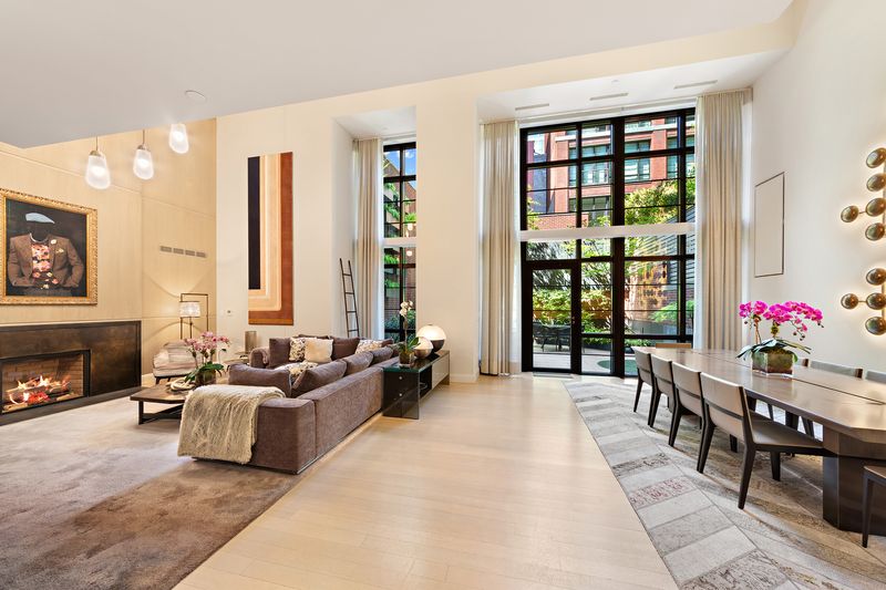 Double-height great room with black-steel windows at 150 Charles Street M10, West Village