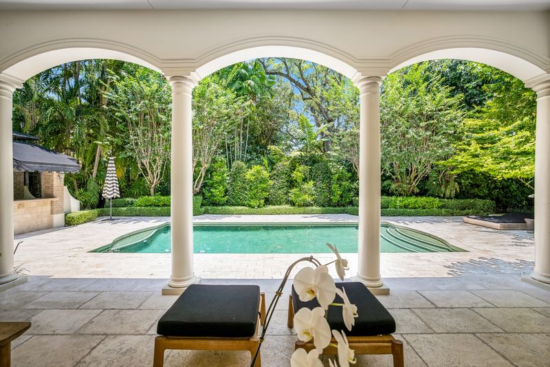 Arched covered terrace overlooking the pool at 155 San Souci Drive, Coral Gables — photo 4 of 9