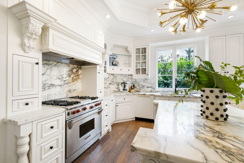 Eat-in kitchen with marble surfaces at 155 San Souci Drive, Coral Gables — photo 6 of 9