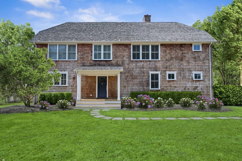 Cedar-shake front facade and gardens at 162 Norris Lane, Bridgehampton — photo 2 of 5