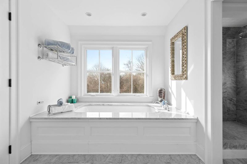 Primary bath with soaking tub and glass shower at 162 Norris Lane, Bridgehampton — photo 4 of 5
