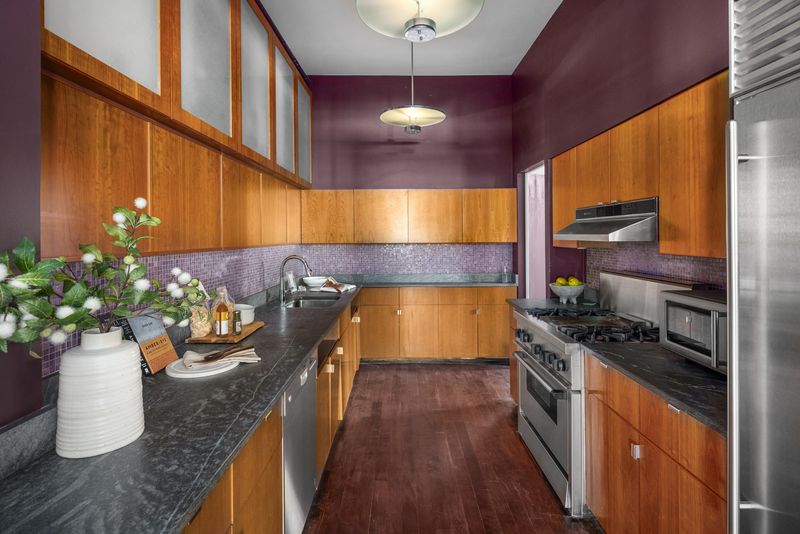 Kitchen with wood cabinetry and stone counters at 170 Fifth Avenue, Unit 5, Flatiron — photo 6 of 10