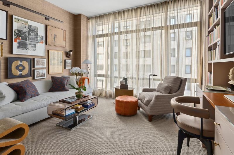 Den with grasscloth walls and floor-to-ceiling windows at 170 East End Avenue 3J, Upper East Side — photo 4 of 9